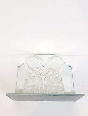 Pair of spun glass swans resting on a mirrored base
